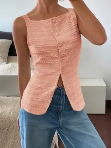 Close-up of peach textured sleeveless top with decorative front buttons and slit