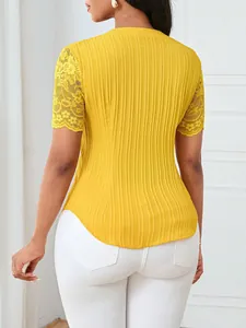 Detailed back view of yellow slim-fit top featuring delicate lace embroidered sleeves.
