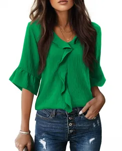 Close-up of women's emerald green V-neck blouse with elegant ruffle detailing and half sleeves