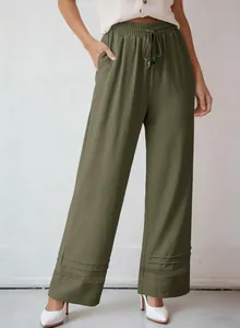 Detail shot of army green wide-leg pants with high waist and hollow lace hem