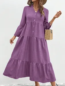 Detailed view of a purple tiered A-line maxi dress with V-neck and button details
