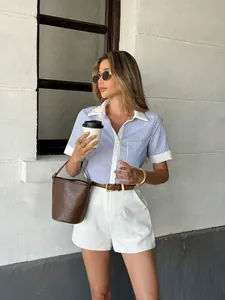 Close-up of women's blue and white striped short sleeve shirt with white polo collar