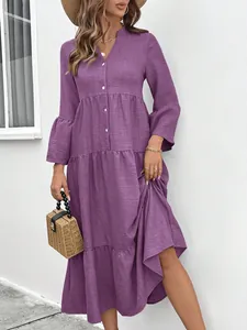Close-up detail of a stylish purple V-neck tiered A-line dress with long ruffled sleeves