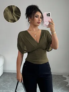 Detail view of olive green ruched waist top with elegant deep V-neck and short sleeves.