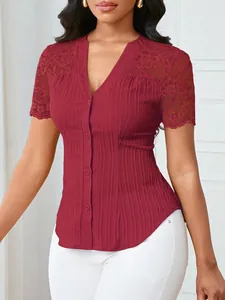 Close-up of elegant burgundy V-neck button-down top with intricate lace shoulder detail
