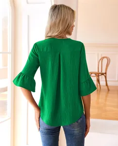 Back view of a green textured blouse featuring ruffle bell sleeves and relaxed fit