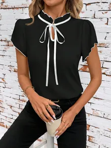 Elegant black ruffle neck blouse with white tie-front detail and flutter short sleeves