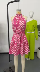 Sleeveless halter neck mini dress featuring pink and white wave pattern print and waist tie