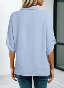 Detailed back view of a light blue textured women's polo shirt with 3/4 sleeves