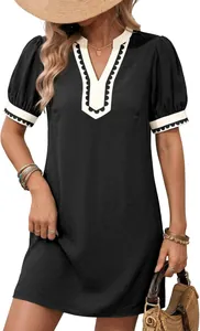 Detail view of black color block V-neck shift dress with scallop trim and puff sleeves