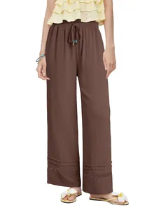 Detail view of brown high-waist wide-leg pants featuring drawstring and lace hollow-out hem.