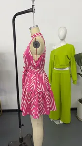Side view detail of a pink and white wavy stripe print halter mini dress on a mannequin