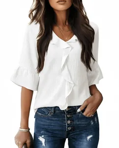Detail view of a white V-neck blouse featuring elegant ruffle bell sleeves