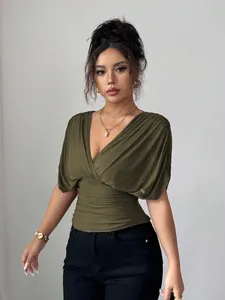 Elegant olive green deep V-neck ruched waist top with chic flutter sleeves shown on model