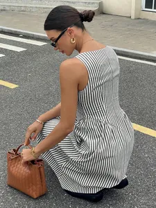 Chic French striped sleeveless maxi dress with a cinched waist shown on model