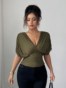 Detail view of deep V-neck olive green top with flutter sleeves and ruched waist