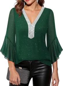 Close-up detail of women's green sparkly V-neck top with silver sequins and flare sleeves.
