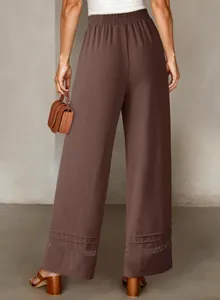Stylish back view of high-waist wide-leg pants in brown with delicate lace hem details