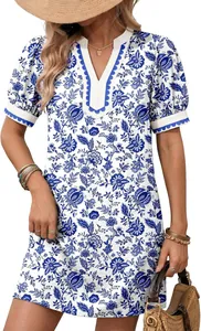 Detail view of blue floral print V-neck dress with scalloped trim and puff sleeves