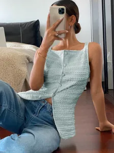 Detail view of light blue textured sleeveless slim fit button-down tank top for women