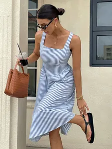 French style blue and white striped sleeveless square neck midi dress styled with a woven bag