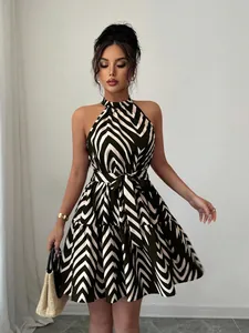 Detail shot of a halter neck sleeveless mini dress with black and white wavy stripes.
