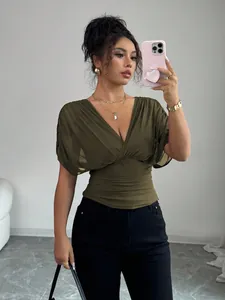Elegant olive green V-neck slim fit top with puff sleeves shown on a fashion model