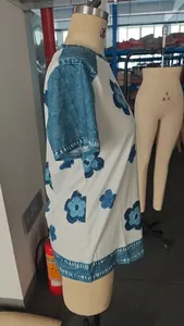 Side view of a women's floral print short sleeve top with blue denim-style trim