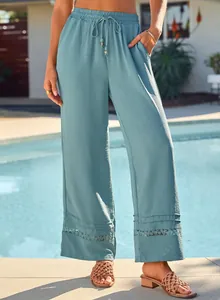 Close-up of casual high waist wide leg trousers featuring a delicate hollow-out lace hem