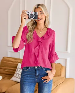 Chic fuchsia V-neck ruffle top featuring three-quarter bell sleeves in a lifestyle setting