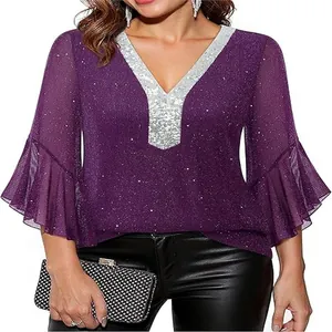 Detail of purple sequin V-neck top with silver glitter panel and flared sleeves