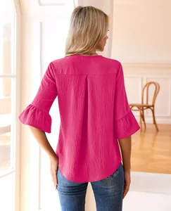 Detailed back view of a fuchsia blouse featuring ruffle sleeves and a pleated back design