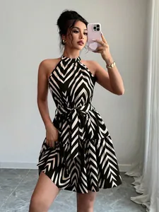Chic halter sleeveless mini dress featuring a bold black and white wave stripe print.