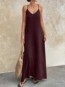 Detail of a burgundy V-neck backless camisole maxi dress with crinkle texture.