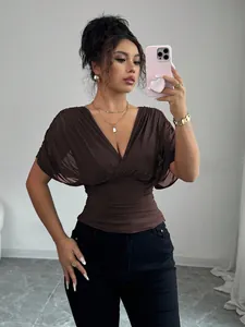 Detailed view of stylish brown deep V-neck top with flutter sleeves and slimming waistline