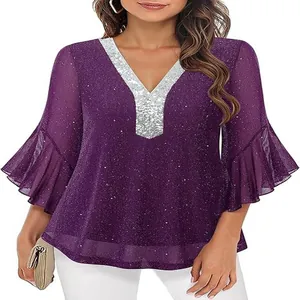 Detail view of purple sequin V-neck top with silver trim and flared sleeves
