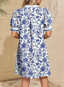Back view of a blue and white floral print short sleeve vacation dress for women