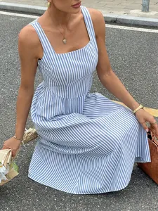 Blue and white striped French style sleeveless dress shown in an outdoor street setting