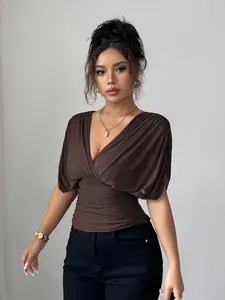 Detail view of a stylish brown deep V-neck ruched waist top with flutter sleeves