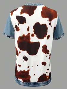 Detailed back view of a women's casual t-shirt with cow print and denim patchwork