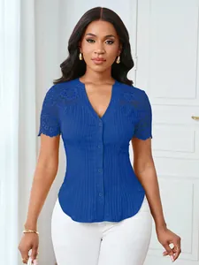 Detail shot of blue slim fit top with elegant embroidered lace sleeves and V-neck.