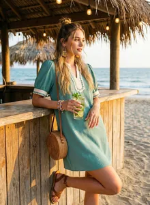 Boho turquoise short sleeve mini dress with white embroidery trim at the V-neck beach bar scene