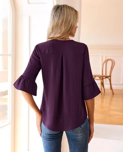 Detailed back view of a purple textured blouse with elegant tiered ruffle sleeves