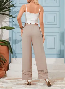 Detailed back view of high-waist wide-leg pants featuring delicate lace cutout detailing