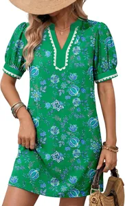 Detail view of a green floral V-neck dress with white lace trim and short puff sleeves.