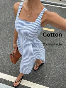Detailed view of a French style blue and white striped cotton dress with square neck.
