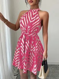 Close-up showing the pink wave stripe pattern on a sleeveless halter summer dress.