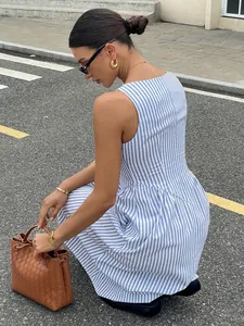 Detailed side view of a chic French-style blue and white striped sleeveless maxi dress.