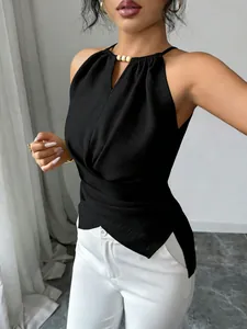 Détail d'un haut dos nu noir élégant avec une taille croisée et des perles au cou.