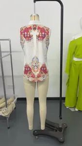 Back view of a sleeveless white shirt featuring a vibrant red paisley print and collar.